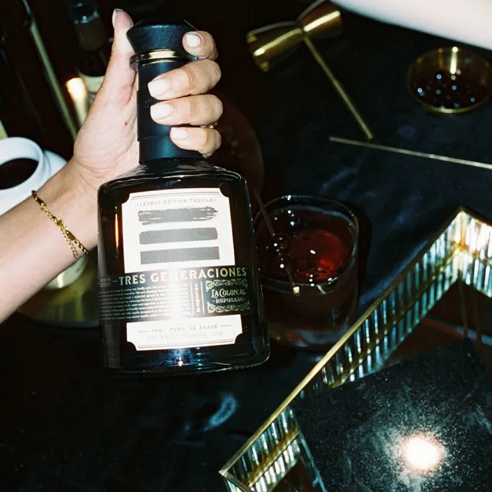 Image of hand holding La Colonial Reposado bottle